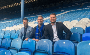 Nick and Danny from One2Call are sat with Sheffield Wednesday Commercial Manager James Todd in the stand at Hillsborough