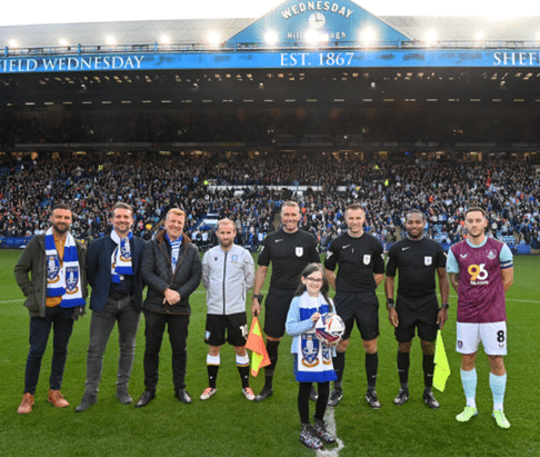 Danny Kirkby of One2Call presenting match ball with guests Scott Riley and Laurence Bass